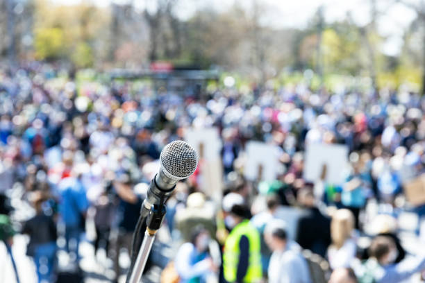 istock Unemployment strike, protest or anti government public demonstration, blurred protesting crowd in the background 1452919696
