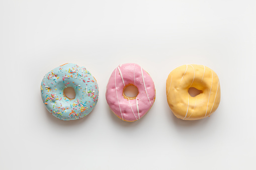 Three Colorful delicious donuts isolated on white background