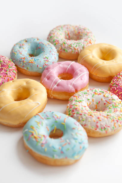 istock Colorful delicious donuts isolated on white background 1452920919