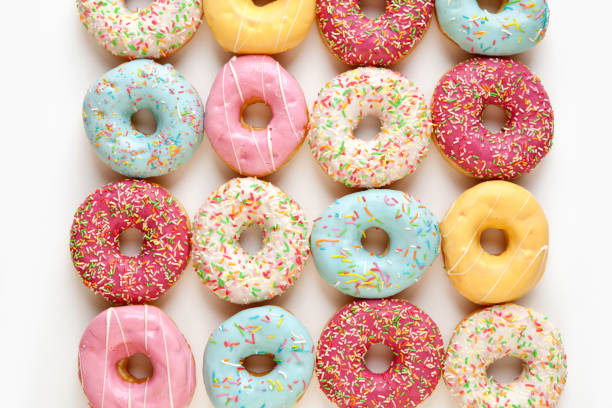 istock Lots of Color donuts isolated on white background 1452920938