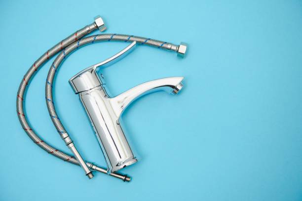 istock Single handle water tap on light blue background, closeup 1452922273