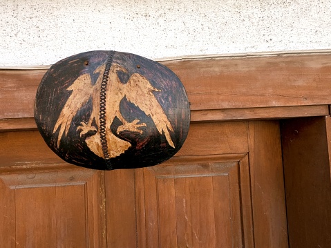 A Double headed hawk symbol of Albania on top of the wooden door