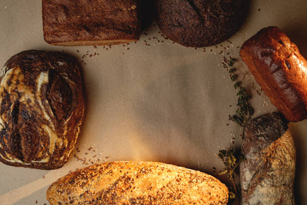 Various types of fresh craft bread with space for text. Top view