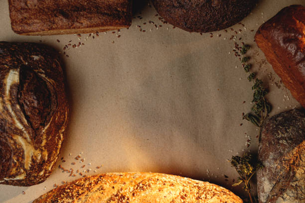 Various types of fresh craft bread with space for text. Top view