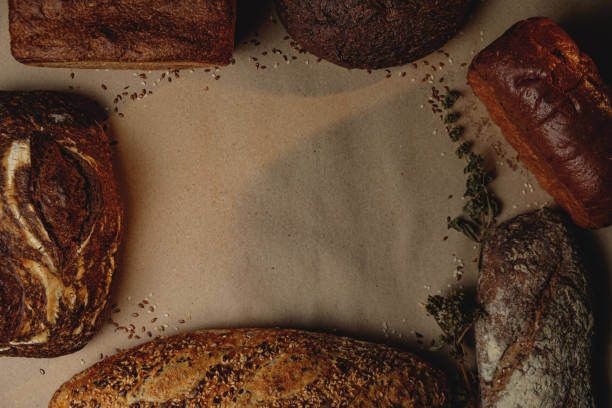 Various types of fresh craft bread with space for text. Top view