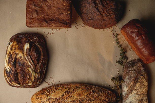 Various types of fresh craft bread with space for text. Top view