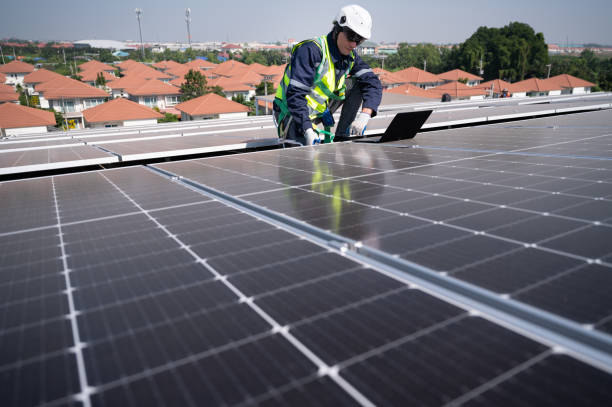 istock Caucasian engineer man use computer notebook working with solar panel on roof factory 1452924250