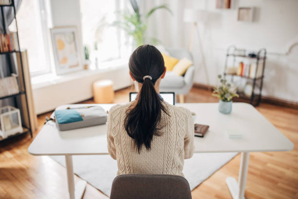 Woman working in home office stock photo