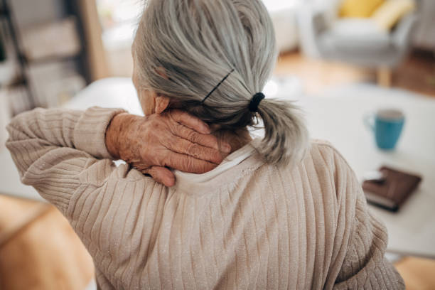 Old woman has neck problems stock photo