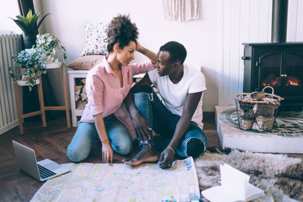 istock Multiracial couple planning trip with map and laptop 1452928954