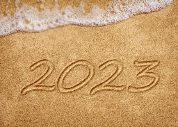 istock 2023 year on the sea shore during the sunset. 1452930043