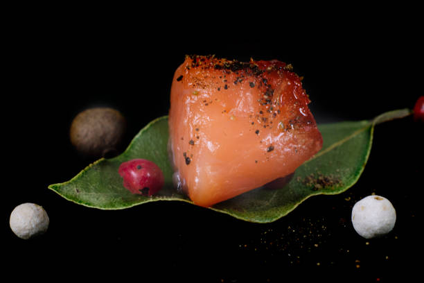 istock yummy small piece of salmon over laurel leaf, side view 1452930277