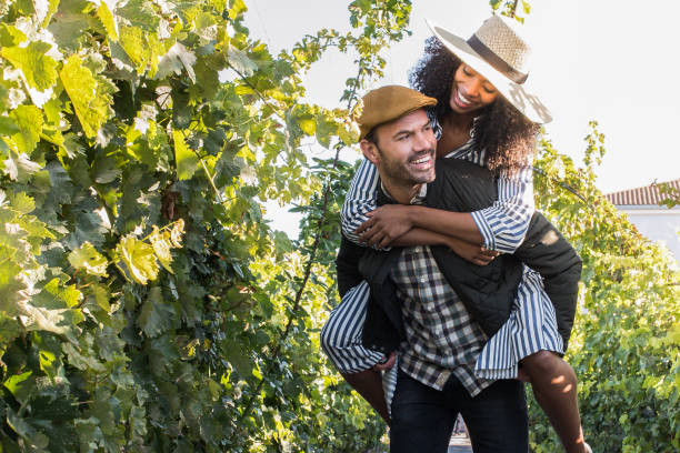 happy young interracial couple on holiday in a vineyard stock photo
