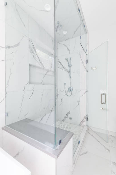 istock A large walk-in shower with marble tiled walls. 1452930763