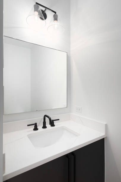 istock A bathroom with a dark vanity and white marble countertop. 1452930798
