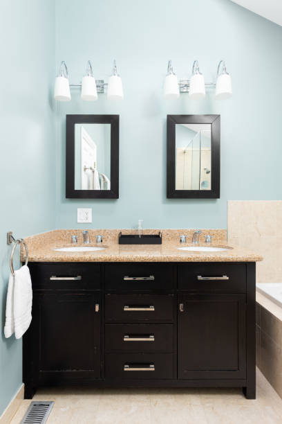 istock A blue bathroom with a wood cabinet and marble countertop. 1452930861