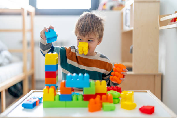 istock Adorable child playing with puzzle pieces at home 1452931755