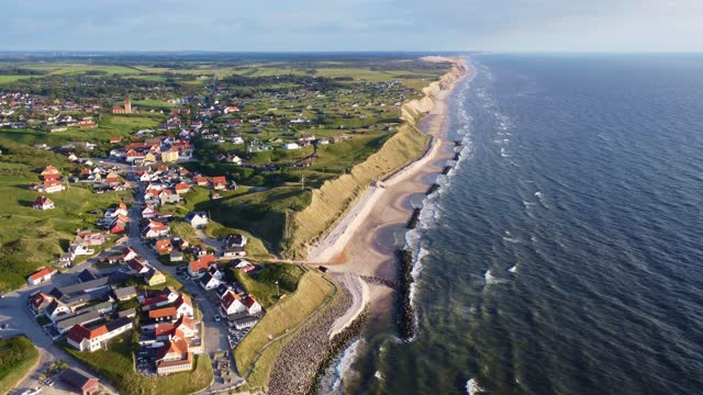 Aerial drone view of the idyllic coast line in Denmark around the village of Lønstrup on a summer day