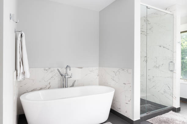 istock A standalone bathtub and marble lined shower. 1452937779