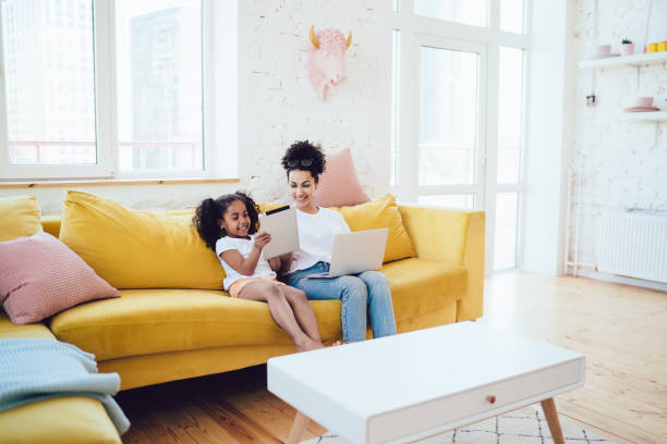 istock Mother and daughter spending time with laptop and tablet 1452938561