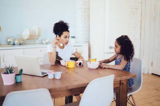 istock Mother and daughter looking at each other in kitchen 1452939166