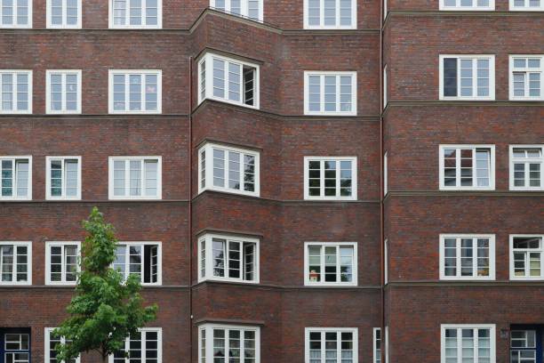 istock Residential brown brick building exterior with windows 1452940681