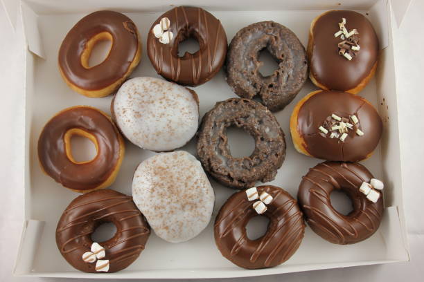 istock chocolate glazed Donuts covered with sugar crumbs in white background isolated close-up. Valentine's donuts. top view 1452940911