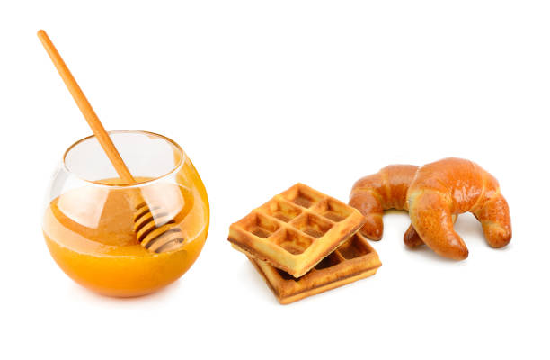 Honey, croissant and waffles isolated on white background.