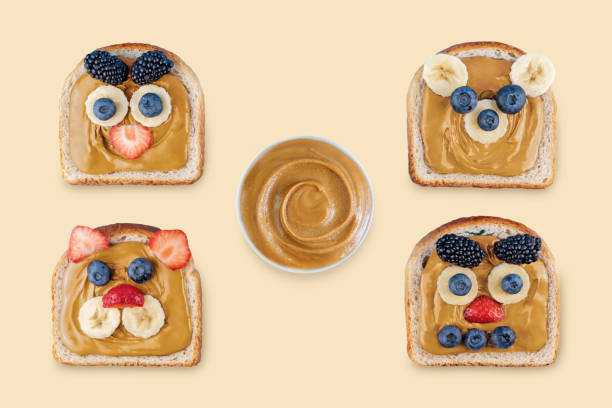 istock Peanut butter with funny sandwiches on a brown background 1452943246