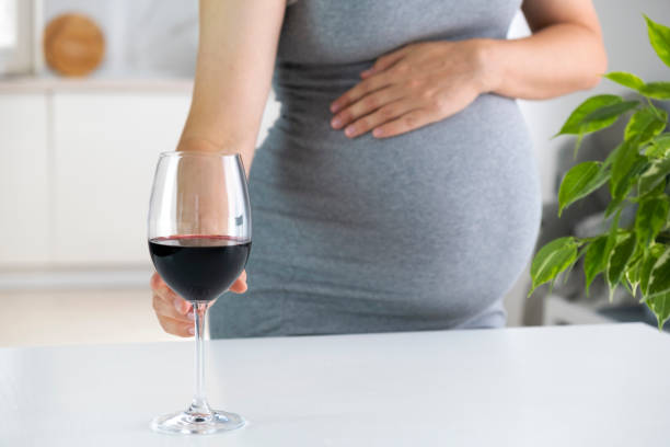 istock Pregnant woman and wine 1452952192