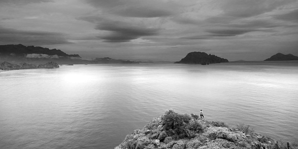 A woman overlooking a beautiful seaside setting in Loreto, Mexico. Black and white image.