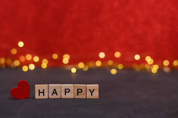 istock the word happy on wooden blocks. red background 1452954163