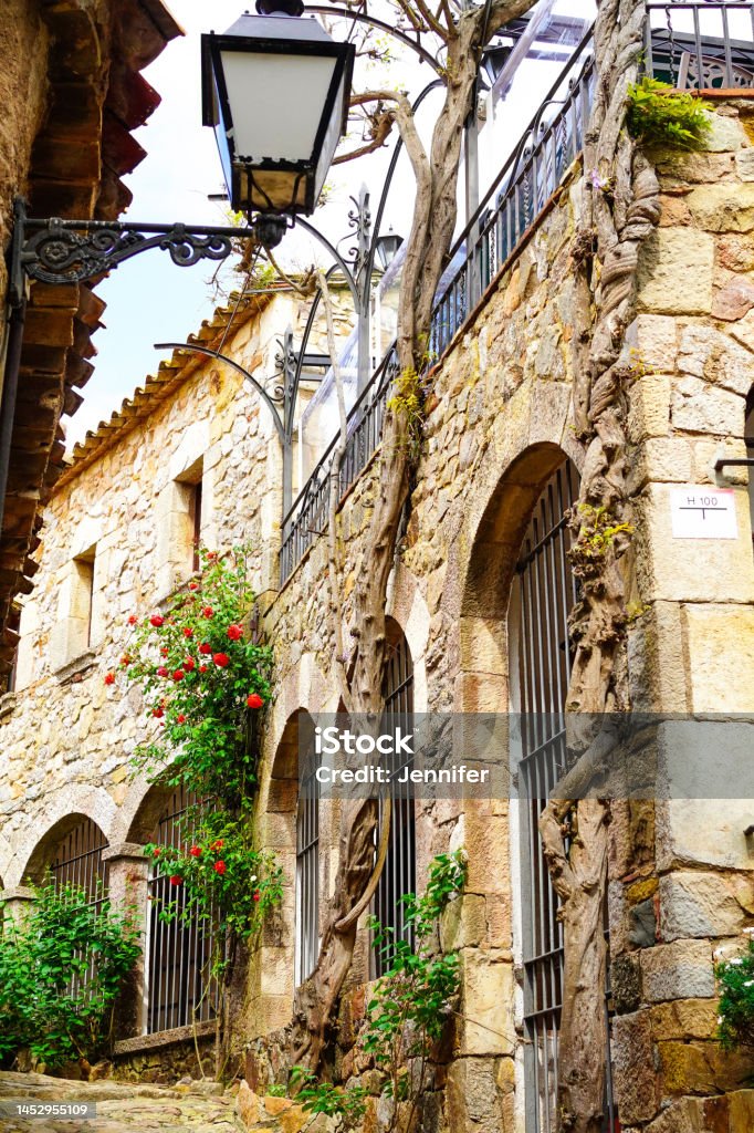 narrow street of old town of Tossa de mar, CostaBrava, Spain Alley Stock Photo