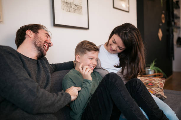 istock Two parents playing with son at home 1452958286