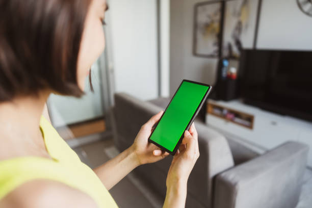 istock Hands holding phone with green screen. 1452961660