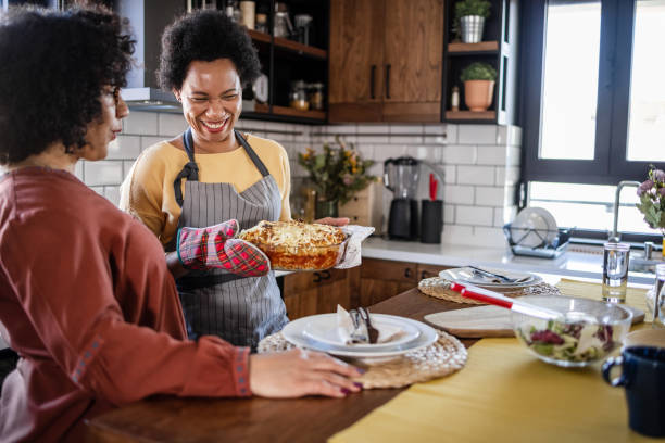 istock Happy lesbian couple cooking together 1452961900