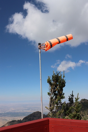 A wind sock blowing in the wind on top of Sandia Mountain in New Mexico