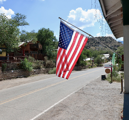 An American flag in front of a store in Madrid, New Mexico