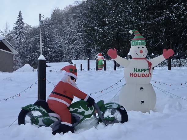 Humorous Christmas scene with inflatable Santa and snowman decorations