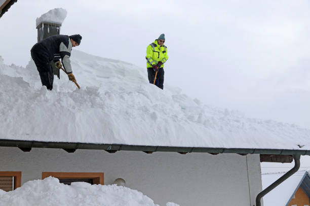 istock Two men shoveling high heavy snow from a house roof 1452970852