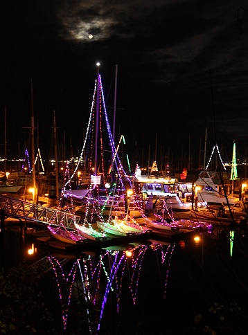 Many Christmas lights on sailboats in the boat harbor of Port Angeles, Washington