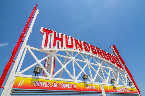 Coney Island, New York, United States - May 19, 2017: Thunderbolt game sign next to entrance of Luna Park.