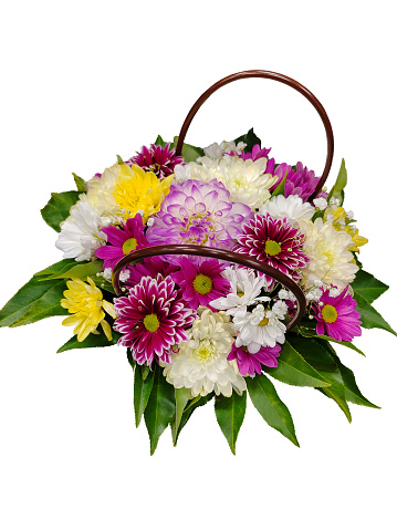 A composition with a bouquet of various fresh bright flowers in a basket on a white background for clipping