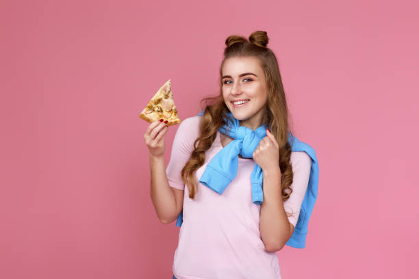 istock Excited woman eating with satisfation pizza slice 1452987539