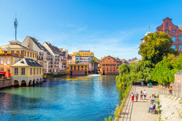 Tourists enjoy a sunny summer day in the Petite France area of Strasbourg, France. Tourists enjoy a sunny summer day in the Petite France area of Strasbourg, France. petite france strasbourg stock pictures, royalty-free photos & images