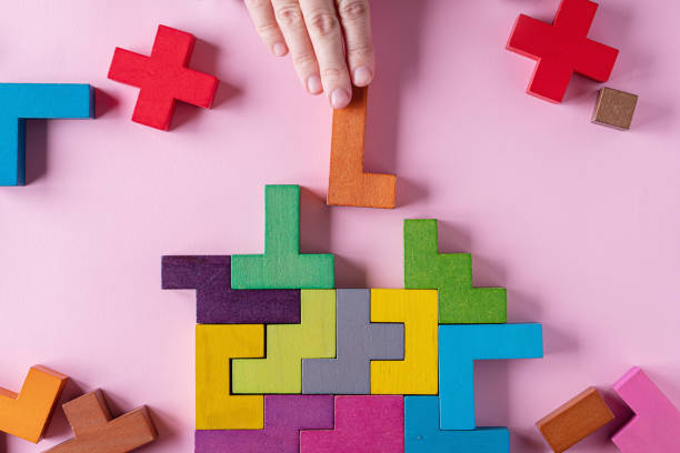 istock Different colorful shapes wooden blocks on pink background 1452995226
