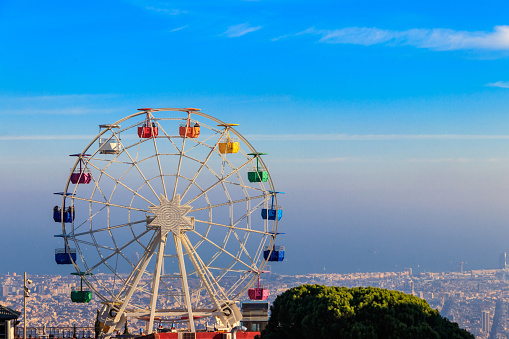 Ferris wheel in Tibidabo mount with panoramic view over Barcelona, Catalonia, Spain