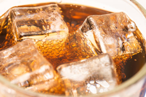 close up cola with ice and bubbles in glass. ice cubes in cola beverage. - drink sport cola can imagens e fotografias de stock