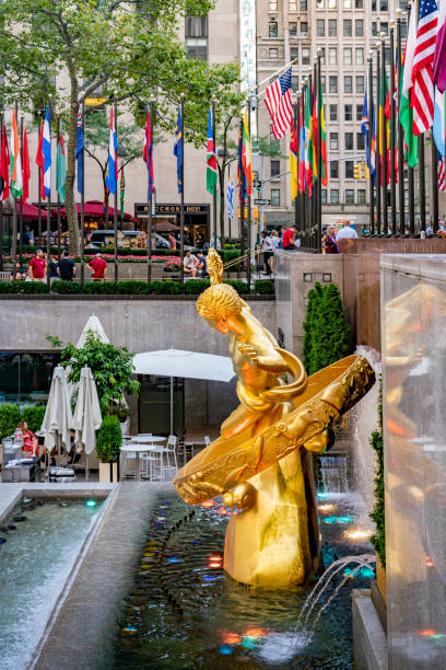 Statue of Prometheus in Rockefeller Center, in Midtown Manhattan, commissioned by the Rockefeller family. United States, New York City - September 14, 2019: Statue of Prometheus in Rockefeller Center, in Midtown Manhattan, commissioned by the Rockefeller family. rockefeller ice rink stock pictures, royalty-free photos & images