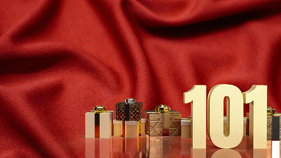 The gold number 101 and gift box on red silk for business concept